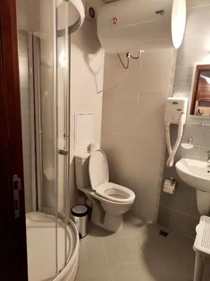 a bathroom with a toilet and a shower and a sink at Апартамент в Белведере Холидей клуб in Bansko