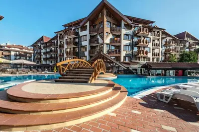 a resort with a swimming pool and a building at Апартамент в Белведере Холидей клуб in Bansko