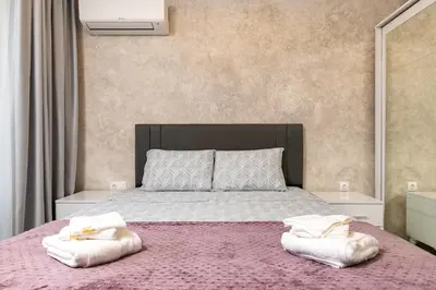 a bedroom with a large bed with two pillows on it at Casa Moderna - Stylish 1BD in South Plovdiv by Flat Manager in Plovdiv