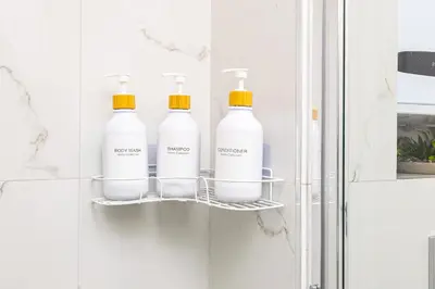 four bottles of bleach on a shelf in a bathroom at Casa Moderna - Stylish 1BD in South Plovdiv by Flat Manager in Plovdiv