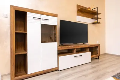 a living room with a tv and a white entertainment center at Casa Moderna - Stylish 1BD in South Plovdiv by Flat Manager in Plovdiv