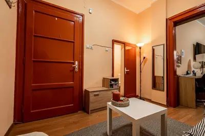 a living room with a red door and a table at Charming Central Retreat! in Sofia