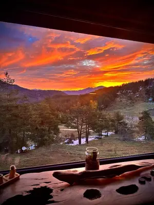 a view of a sunset from a window with a table at Villa INDIANA Devin in Devin