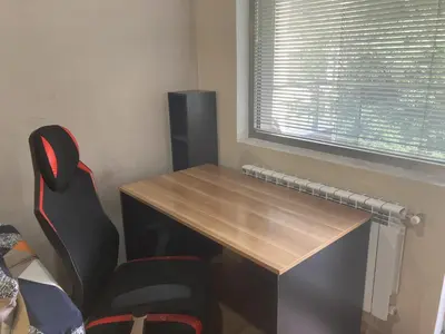 a desk and a chair in a room with a window at Kyluks 1BR Apartment in Sofia