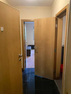 a hallway with two doors and a room at Kyluks 1BR Apartment in Sofia