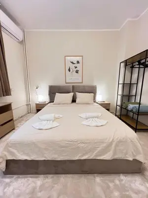 a bedroom with a large bed with two towels on it at Cozy 1BDR with Jacuzzi and WiFi near Vitosha BLVD in Sofia