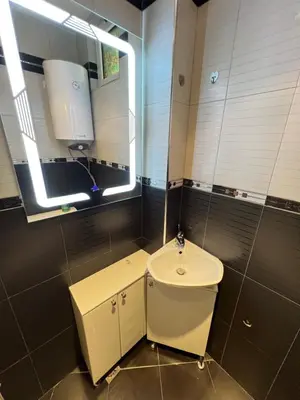 a small bathroom with a toilet and a window at Cozy 1BDR with Jacuzzi and WiFi near Vitosha BLVD in Sofia