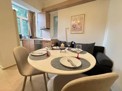 a dining room table with wine glasses on it at Cozy 1BDR with Jacuzzi and WiFi near Vitosha BLVD in Sofia
