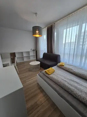 a room with two beds and a chair in it at Happy Home in Sofia