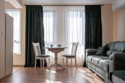 a living room with a couch and a table and chairs at 5 Villa Vitosha Classic Stays in Hisarya