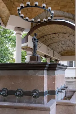 a statue under a building with a chandelier at 5 Villa Vitosha Classic Stays in Hisarya