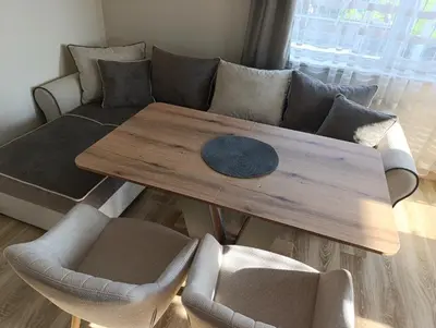 a living room with a wooden table and a couch at Самостоятелен Apartment Emili in Sapareva Banya