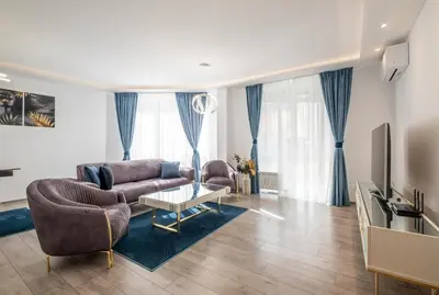 a living room with two couches and a tv at Elegant Deluxe 2 Bedroom apartment in Sofia