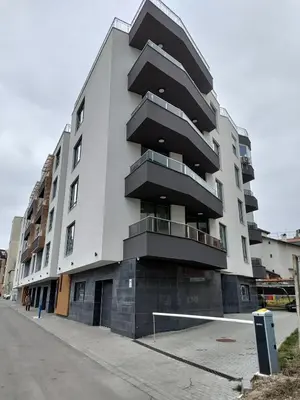 a large white building with balconies on a street at Elegant Deluxe 2 Bedroom apartment in Sofia