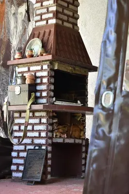 an outdoor brick oven with aperature at Диковата къща in Lesidren