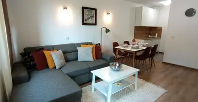 a living room with a couch and a table at Апартамент ДАРА in Smolyan