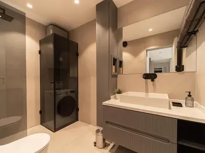 a bathroom with a sink and a toilet and a shower at APEX Apartments Sofia - MountainView in Sofia