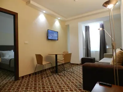 a hotel room with a couch and a table at Central Hotel Sofia in Sofia