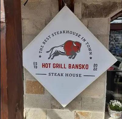 a sign for a hot grill banjo steak house at Lara's cosy apartment 200 m from lift in Bansko