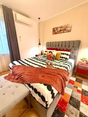 a bedroom with a bed with a black and white comforter at Luxury apartment in the heart of Sofia in Sofia