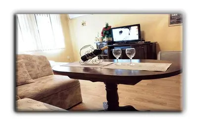 a table with two wine glasses on it in a living room at Studio Resonance Bansko in Bansko