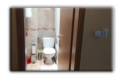 a bathroom with a white toilet in a room at Studio Resonance Bansko in Bansko