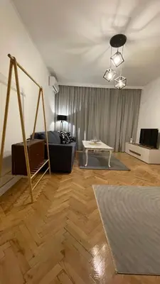 a living room with a couch and a table at Кокетно Кътче in Sofia