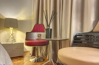 a room with a table and two chairs and a lamp at Superbe last floor next Presidency in Sofia