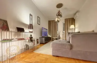 a living room with a couch and a television at Superbe last floor next Presidency in Sofia