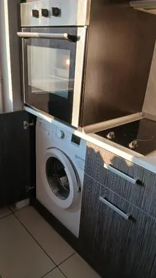 a washing machine in a kitchen with a microwave at Studio Kalo in Sofia