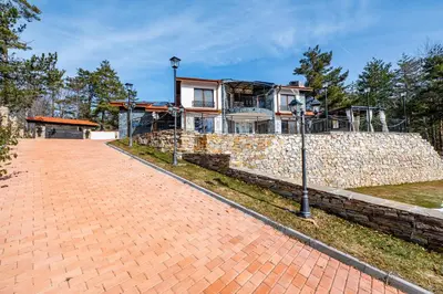 a house on top of a stone wall at Планинска вила АЛТЕА in Mostowo