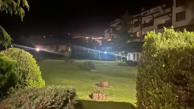 a grassy yard at night with a train at Eleonor Mountain Apartment 2 in Bansko