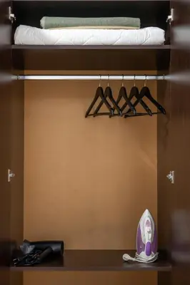 a closet with a shelf with hangers and a bed at Martin's Treasure TOP CENTER in Sofia