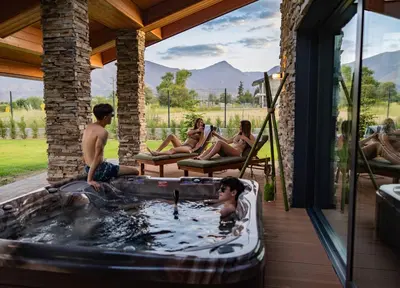 a group of people sitting in a hot tub at Hypnotic Thermal Villas with private SPA in Banya