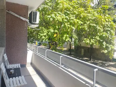 a balcony with two white benches and a tree at Central Vintage Apartment for 4 Guests & Private Parking in Plovdiv