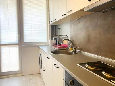 a kitchen with a sink and a counter with windows at Central Vintage Apartment for 4 Guests & Private Parking in Plovdiv