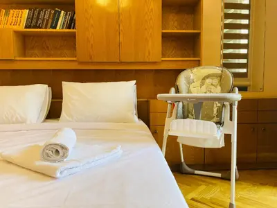 a room with a bed with a chair and a mirror at Central Vintage Apartment for 4 Guests & Private Parking in Plovdiv