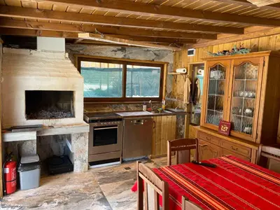a kitchen with a stove and a counter top at Къща за гости Хриси in Mala Tsŭrkva