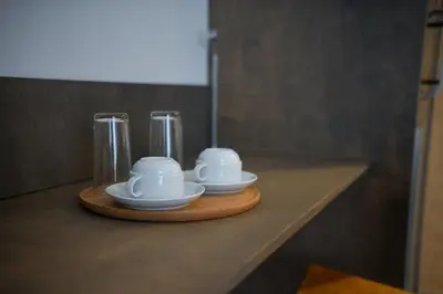 three cups and saucers sitting on a counter at Villa Alveare in Banya