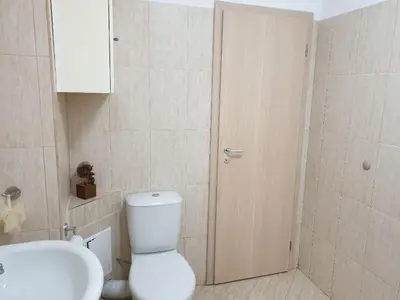 a bathroom with a toilet and a sink at Уютнен апартамент Лагера in Sofia