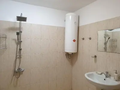 a bathroom with a shower and a sink at Уютнен апартамент Лагера in Sofia