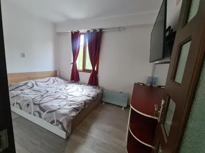 a bedroom with a bed and a window with purple curtains at Cosmopolitan in Devin