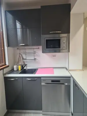 a kitchen with a sink and a microwave at Cosmopolitan in Devin