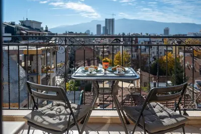 a table with food on top of a balcony at Skyline Studio in Sofia