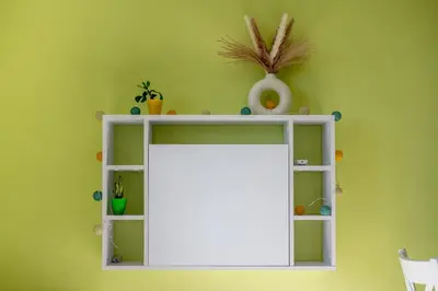 a white shelf with a mirror on a green wall at Skyline Studio in Sofia