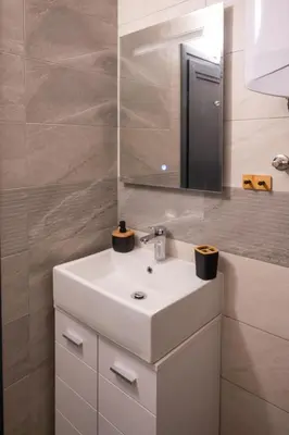 a bathroom with a white sink and a mirror at Skyline Studio in Sofia