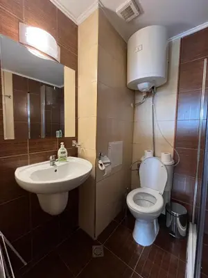 a bathroom with a toilet and a sink at Spacious Studio - Bansko Royal Towers in Bansko