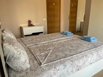 a bedroom with a bed with two towels on it at Апартамент в сърцето на ПЛОВДИВ in Plovdiv