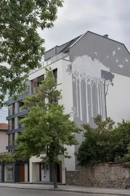 a building with a painting on the side of it at Апартамент в сърцето на ПЛОВДИВ in Plovdiv