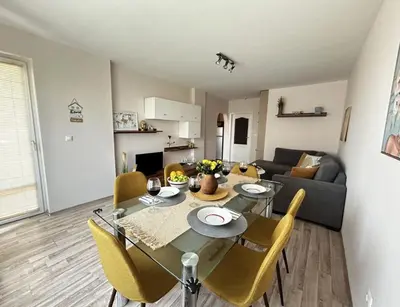 a dining room and living room with a table and chairs at Rea Flora - Cozy Stay With Free Parking in Sofia